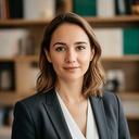 Portrait of Isabel Montero in a tailored suit inside a Madrid law office